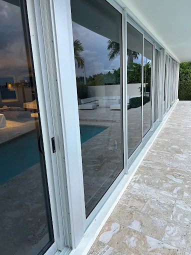 Large white-frame sliding doors on pool patio — San Diego