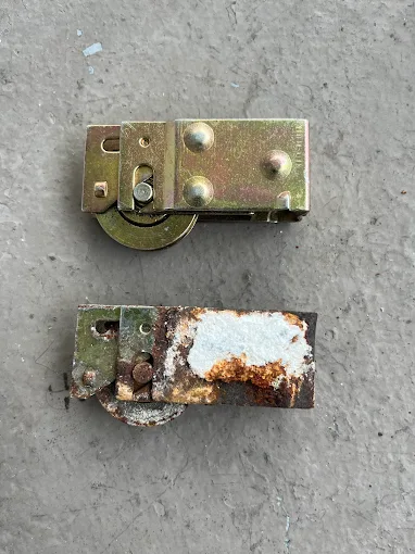New vs corroded sliding door rollers — before and after